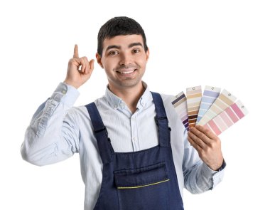 Male painter with color palettes pointing at something on white background