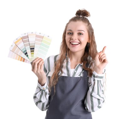 Female artist with paint color palettes pointing at something on white background