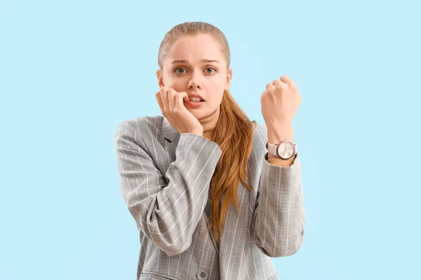 Young Businesswoman Wristwatch Biting Nails Blue Background — Stock Photo, Image