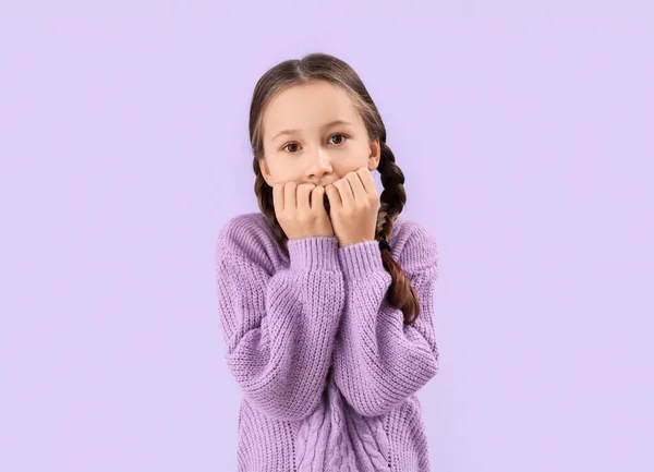 Little Girl Biting Nails Lilac Background — Fotografie, imagine de stoc