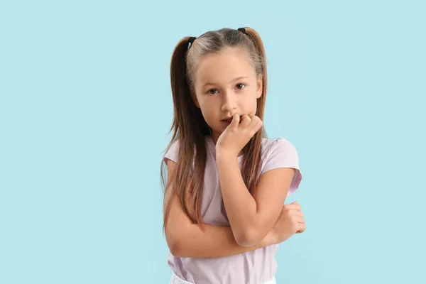 Little Girl Biting Nails Blue Background — Foto Stock