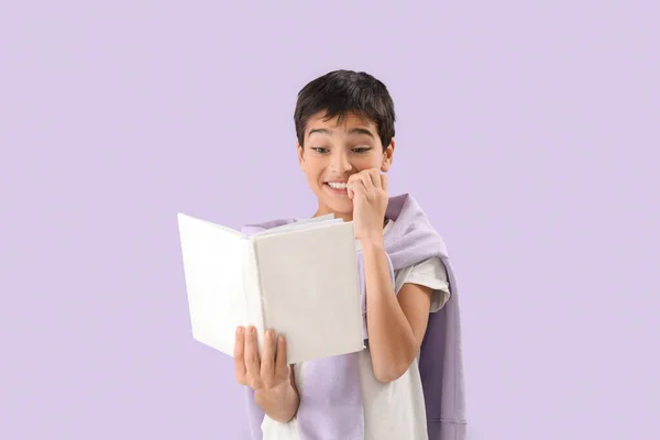Little Boy Book Biting Nails Lilac Background — Stock Photo, Image