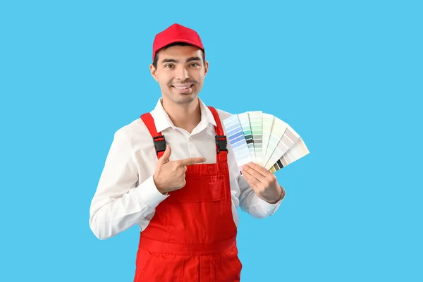 Male Painter Pointing Color Palettes Blue Background — Fotografia de Stock