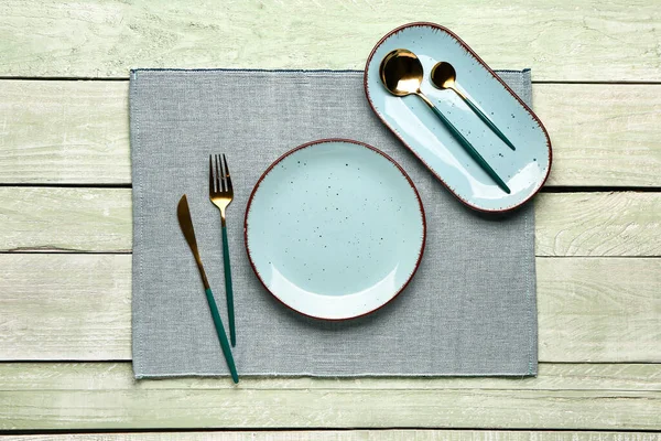 Blue Tablecloth Plates Set Cutlery Green Wooden Background — Foto Stock