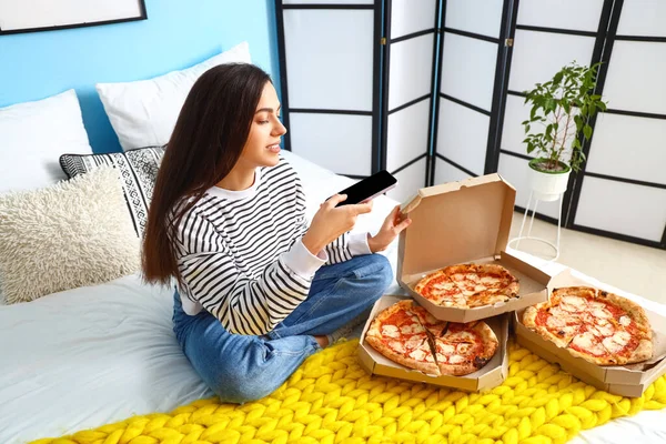 Young Woman Mobile Phone Taking Picture Tasty Pizza Bedroom — Stock Photo, Image