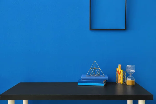 Workplace Stationery Books Hourglass Blue Wall — Stock Photo, Image