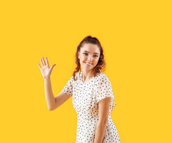 Beautiful Young Woman Waving Hand Yellow Background — Stock Photo, Image