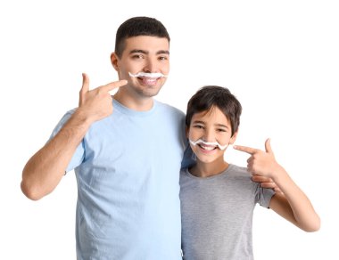 Father and his little son with shaving foam on faces against white background