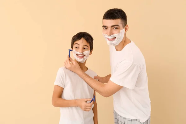 Father His Little Son Shaving Beige Background — Zdjęcie stockowe