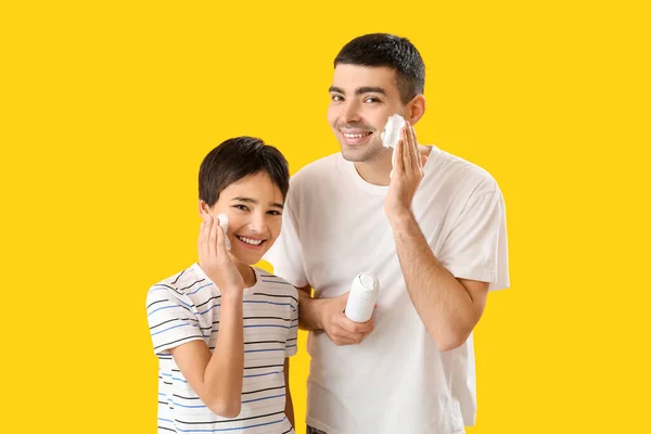 Man His Little Son Applying Shaving Foam Faces Yellow Background — Stockfoto