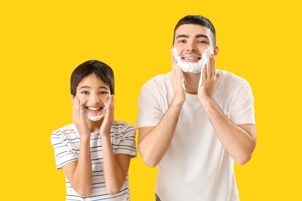 Man His Little Son Applying Shaving Foam Faces Yellow Background — Stock Photo, Image