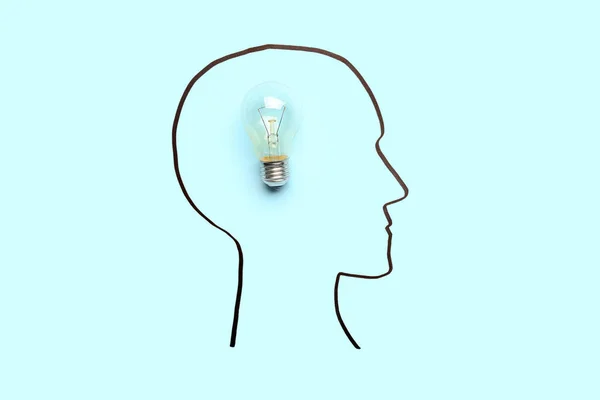 Drawn human head with light bulb on blue background. Insight concept