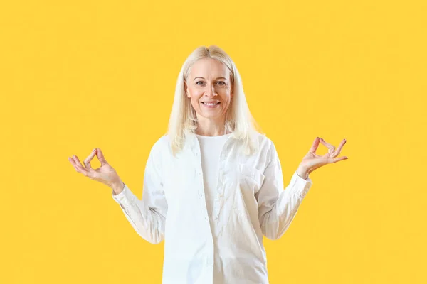 Mature Woman Meditating Yellow Background — Stock Photo, Image
