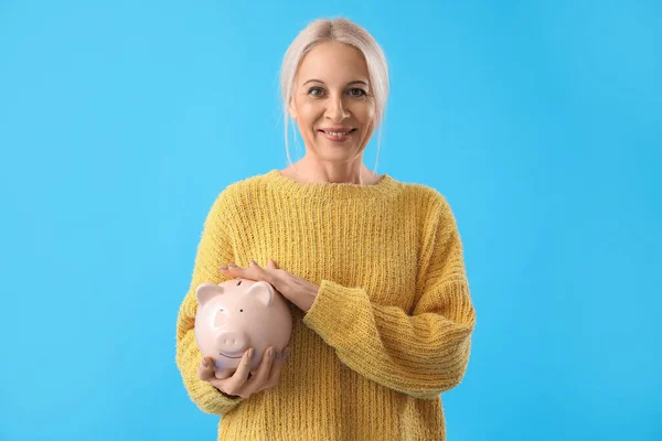 Mature Woman Piggy Bank Blue Background — Stock Photo, Image