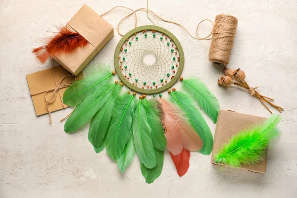 Dream catcher with gifts and envelope on white background
