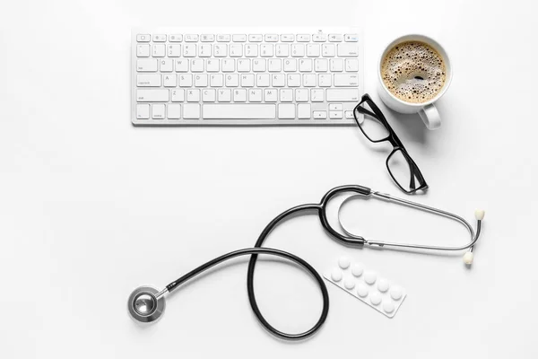 Stethoscope Keyboard Glasses Coffee Pills White Background — Stock Photo, Image