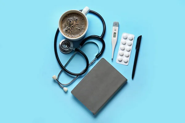 Stethoscope Notebook Coffee Pills Blue Background — Stock Photo, Image