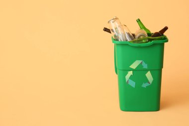 Bej arka planda cam şişeler olan çöp kutusu. Geri dönüşüm kavramı