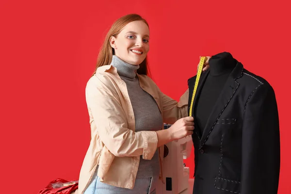 Female Dressmaker Measuring Jacket Red Background — Stock Photo, Image