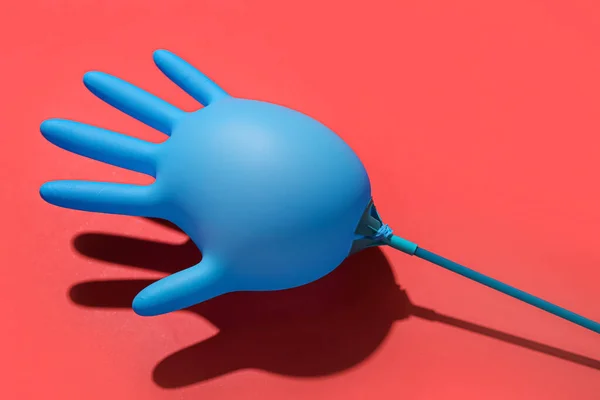 Inflated Medical Glove Red Background — Stock Photo, Image
