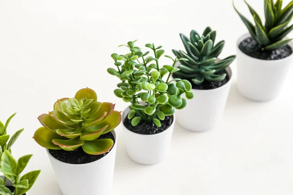 Artificial plants on white background, closeup