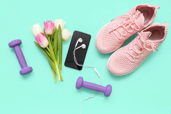 Sneakers Dumbbells Mobile Phone Earphones Tulips Color Background — Stock Photo, Image