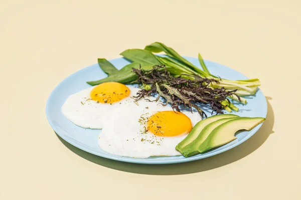 Plate Tasty Fried Eggs Greens Beige Background — Stock Photo, Image