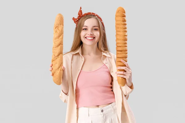 Young Woman Fresh Baguettes Grey Background — Zdjęcie stockowe