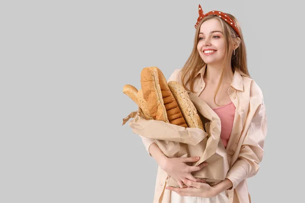 Young Woman Fresh Baguettes Grey Background — Stock Photo, Image