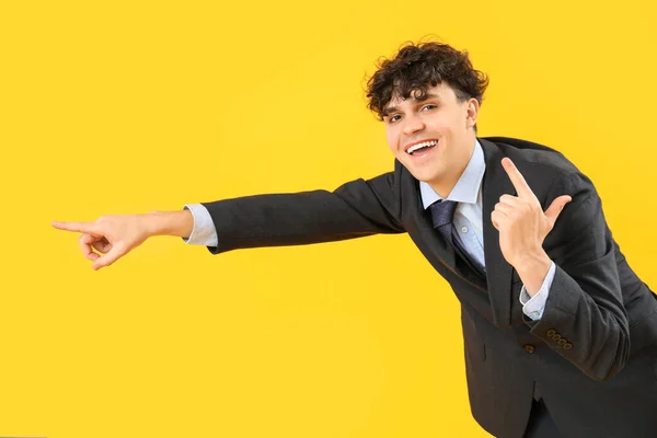 Laughing Young Businessman Showing Loser Gesture Pointing Something Yellow Background — Stock Photo, Image