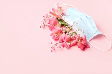 Pembe arka planda çiçekli tıbbi maske. Astım konsepti
