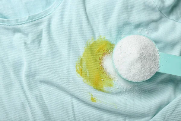 Laundry detergent on stained clothes, closeup