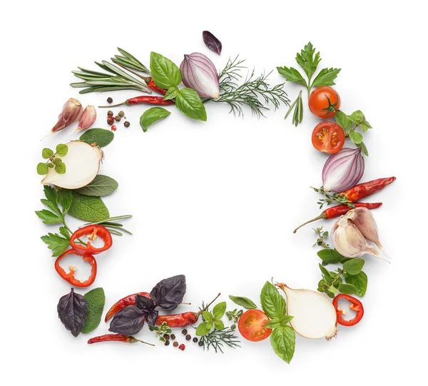 Frame made of fresh herbs, aromatic spices and vegetables on white background