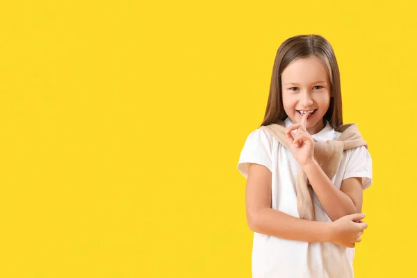 Little Girl Biting Nails Yellow Background — Photo