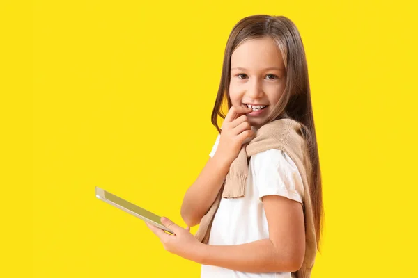 Little Girl Tablet Computer Biting Nails Yellow Background — Stock Photo, Image
