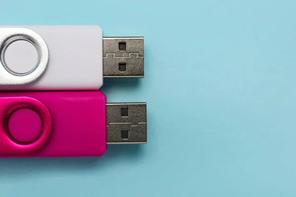 USB flash drives on color background, closeup