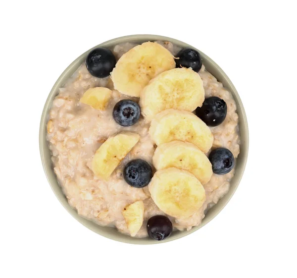 stock image Bowl with tasty oatmeal, blueberries and bananas isolated on white background