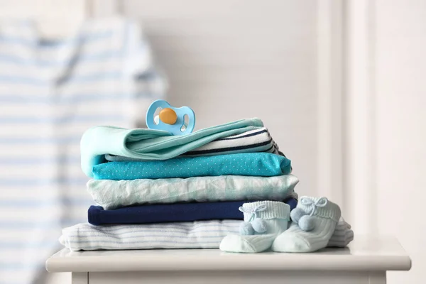 Stack Baby Clothes Pacifier Table Room Closeup — Stock Photo, Image