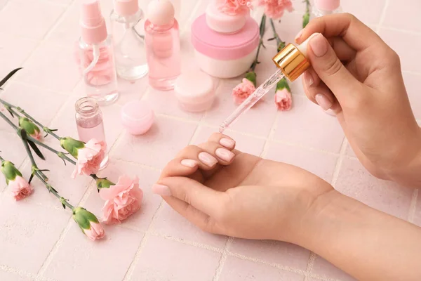 Female Hands Bottle Cuticle Oil Cosmetics Carnation Flowers Color Tile — Stock Photo, Image