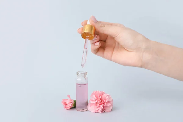 Female Hand Bottle Cuticle Oil Carnation Flowers Light Background — Stock Photo, Image