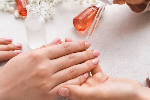 Manicure Master Applying Cuticle Oil Female Fingernails Light Background Closeup — Stock Photo, Image
