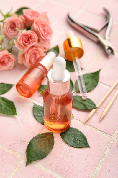 Composition Bottles Cuticle Oil Manicure Instruments Rose Flowers Color Tile — Stock Photo, Image