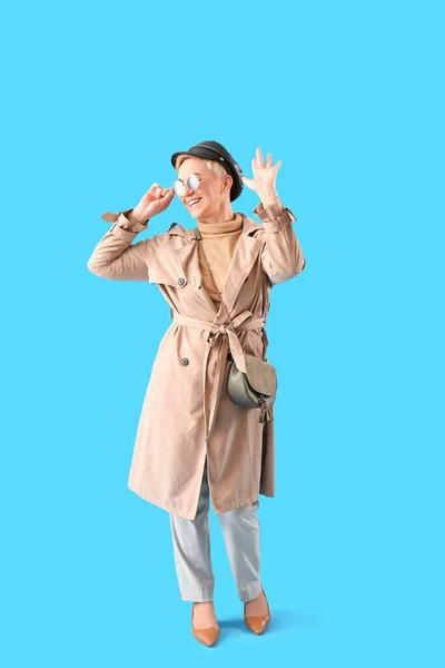 Stylish Mature Woman Waving Hand Light Blue Background — Stock Photo, Image
