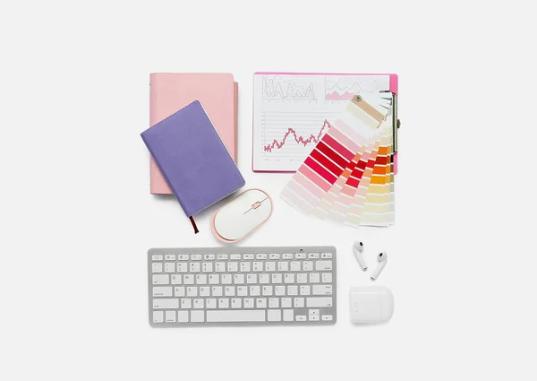 Composition with keyboard, notepad, documents and mouse on white background