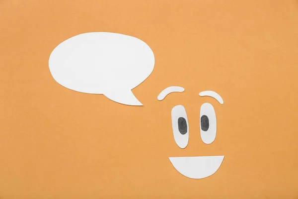 Happy face with speech bubble on orange background. Dialogue concept