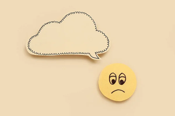 Sad smile with speech bubble on beige background. Dialogue concept