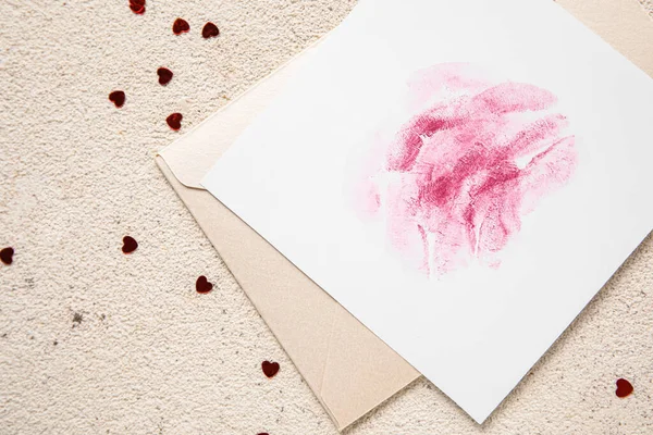 stock image Envelope with lipstick kiss marks and hearts on grunge background