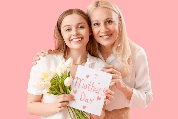 Young Woman Greeting Her Mother Tulips Card Pink Background — Stock Photo, Image