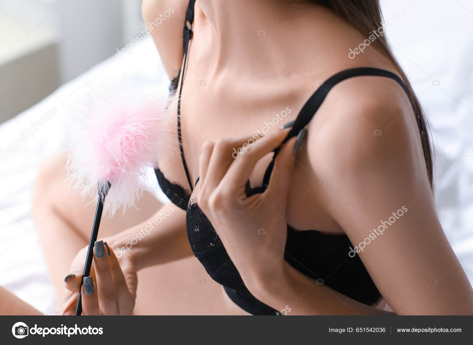 Young Woman Underwear Feather Stick Sex Shop Bed Closeup Stock Photo by ©serezniy 651542036