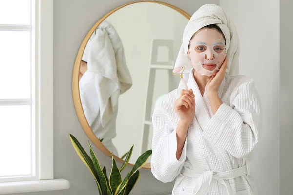 Young Woman Sheet Mask Facial Massage Tool Bathroom — Stock Photo, Image